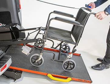 Wheel chair being pushed into a vehicle