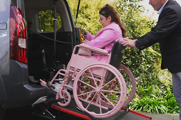 Lady in pink in Wheelchair moving into WAV