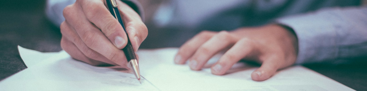 Person using a mechanical pencil writing on paper