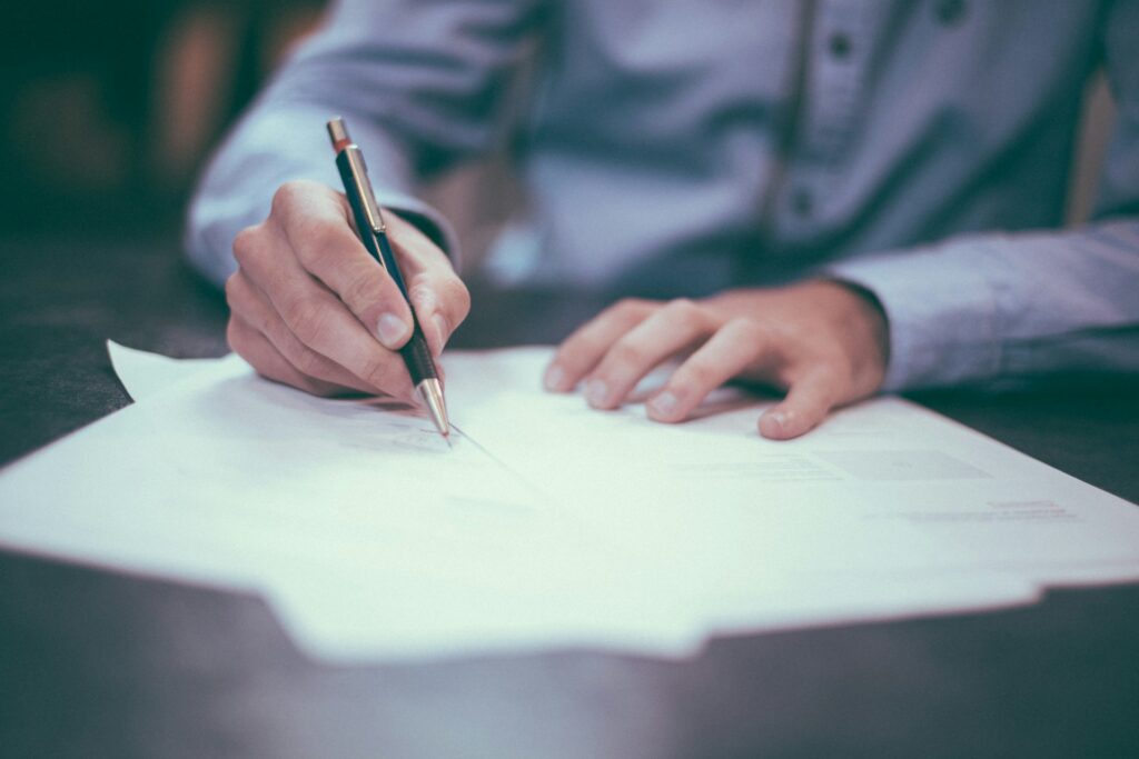 Person using a mechanical pencil writing on paper