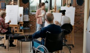 Disability awareness days – wheelchair user taking part in a community art class